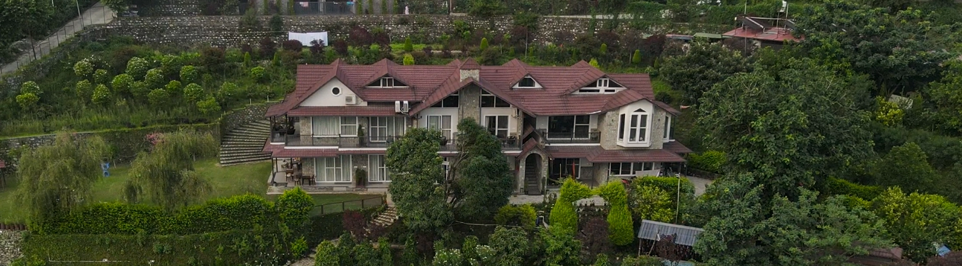 The villa exterior at blue hour, lights on in the windows, Willowdale Naukuchiatal